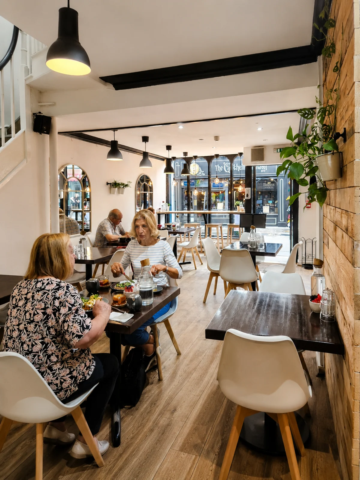 Guests enjoying food inside the bright Goodramgate café dining room
